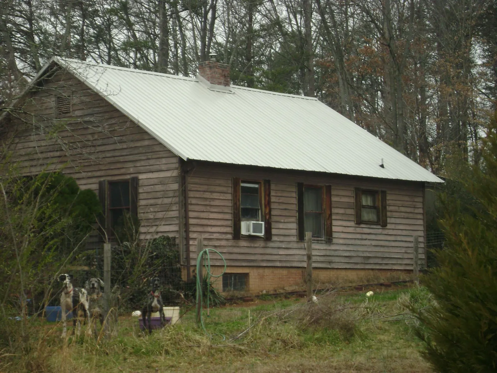 White metal roof on an old wood sided farmhouse, from a Metal Roof Installation job in Tarrytown